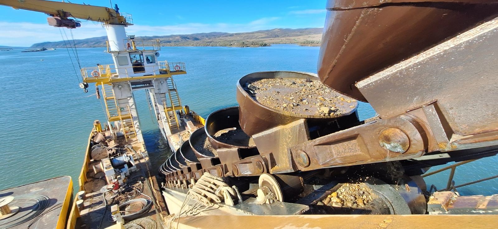 Bucket-chain dredger working on a river